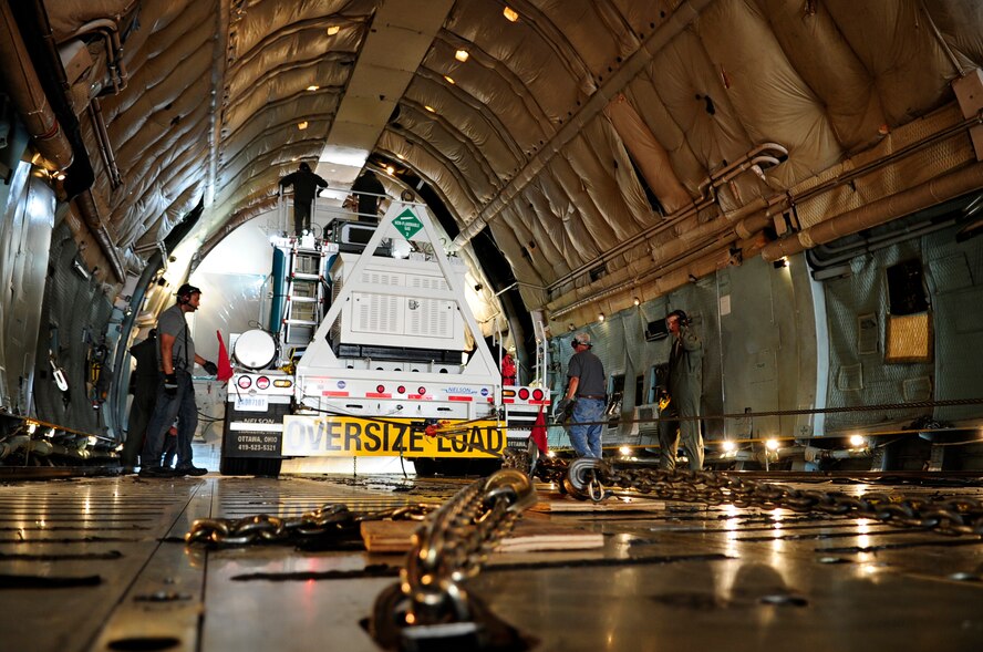 Crew members carefully ease the Pathfinder out of the C-5C Galaxy’s cargo area during the unloading process at Joint Base Andrews, Md., July 17, 2014.  This C-model Galaxy from the 22nd Airlift Squadron at Travis Air Force Base, Calif., is one of two “space cargo modified” planes in the Air Force fleet.  The planes were customized to carry satellites and large cargo, and routinely support the NASA mission by delivering assets throughout the nation. (U.S. Air Force photo/Staff Sgt. Torey Griffith)