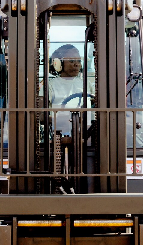 Airman 1st Class Gelisha Jones, an air transportation specialist from the 89th Aerial Port Squadron, wheels a forklift as she places metal ramps on a specially modified C-5 Galaxy in preparation to unload a massive piece of NASA’s James Webb Space Telescope at Joint Base Andrews, Md., July 17, 2014. Crews from the 89th APS, 22nd Airlift Squadron out of Travis Air Force Base, Calif., and NASA’s Goddard Space Flight Center in Greenbelt, Md., worked together to deliver the cargo. (U.S. Air Force photo/U.S. Air Force photo/Staff Sgt. Torey Griffith)