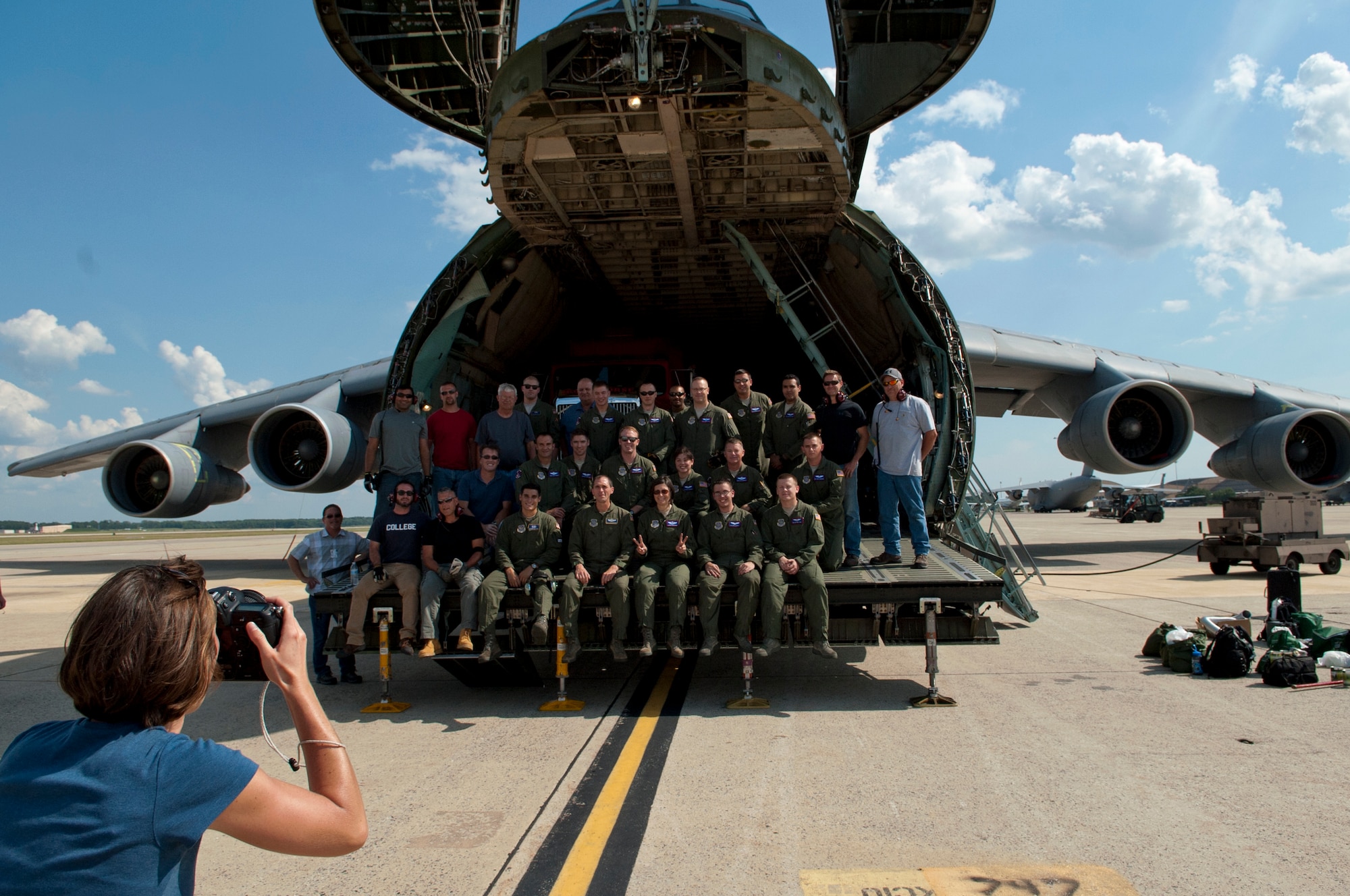 Desiree Stover, a photographer from NASA’s Goddard Space Flight Center in Greenbelt, Md., photographs the crew who transported the Pathfinder test piece for NASA’s James Webb Space Telescope from Los Angeles International Airport in California to Joint Base Andrews, Md., July 17, 2014.  Teams from NASA and the 22nd Airlift Squadron from Travis Air Force Base, Calif., worked together to move the Pathfinder.  The 89th Aerial Port Squadron from Andrews assisted with manpower and equipment. (U.S. Air Force photo/Staff Sgt. Torey Griffith)