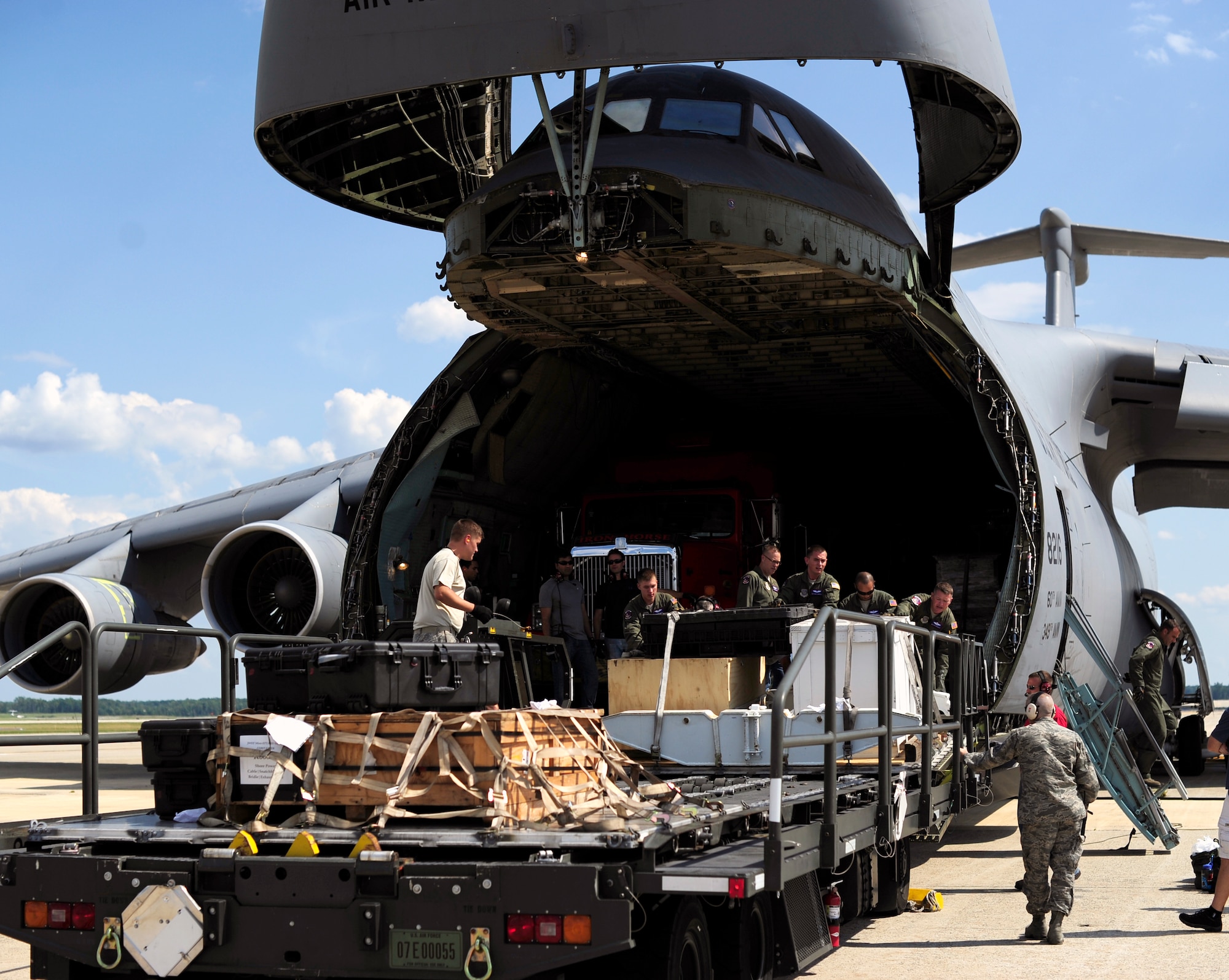 Airmen from the 89th Aerial Port Squadron and the 22nd Airlift Squadron unload equipment from a specially modified C-5C Galaxy which transported parts of NASA’s James Webb Space Telescope from Los Angeles International Airport in California to Joint Base Andrews, Md., July 17, 2014.  The “Pathfinder” is a test piece for the space telescope, which is currently being assembled at Goddard Space Flight Center in Greenbelt, Md. (U.S. Air Force photo/Staff Sgt. Torey Griffith)