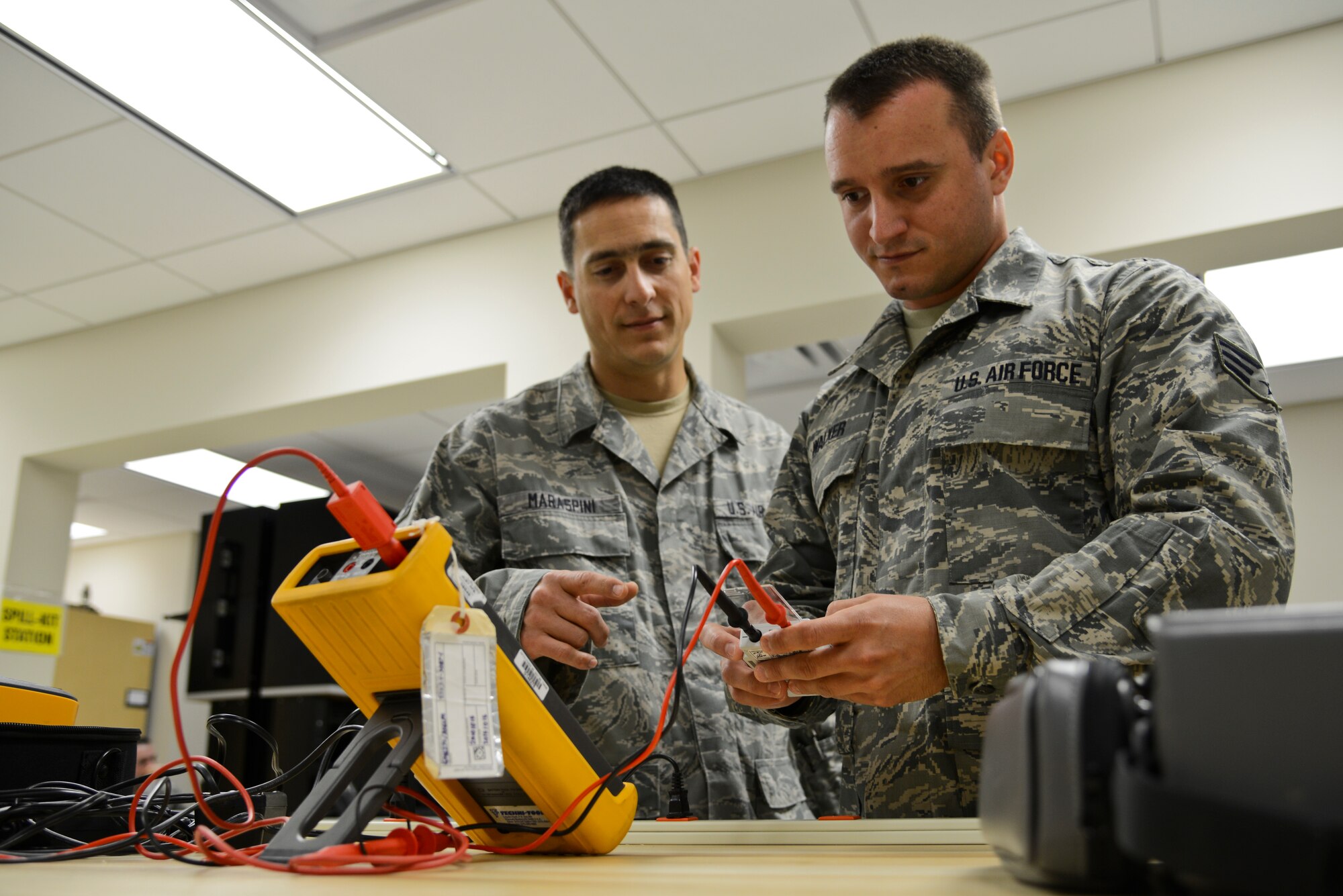 U.S. Air Force Reserve Staff Sgt. Isaac Maraspini, 445th Aeromedical Staging Squadron biomedical equipment craftsman, and Senior Airman Ryan Walker, 445th ASTS biomedical equipment technician, test a pacemaker during their tour of USAF Hospital Langley at Langley Air Force Base, Va., July 21, 2014. During their tour, the Reservists completed biannual refresher training to remain mission-qualified. (U.S. Air Force photo by Airman 1st Class Devin Scott Michaels/Released)