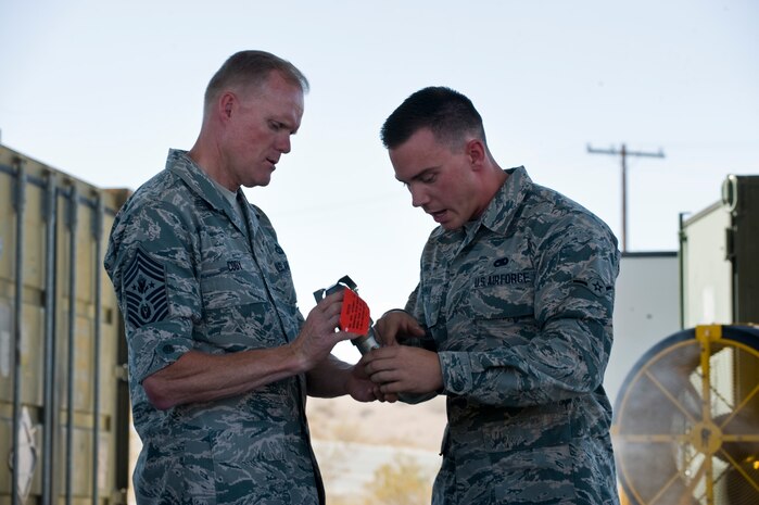 Airman Christian Inman, 57th Maintenance Squadron munitions system apprentice, speaks to Chief Master Sgt. of the Air Force, James A. Cody July 18, 2014, during a visit to Nellis Air Force Base, Nev. Chief Cody is the 17th chief master sergeant appointed to the highest noncommissioned officer position. (U.S. Air Force photo by Senior Airman Jason Couillard)