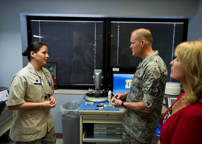 Staff Sgt. Julie Sabin, 99th Dental Squadron dental laboratory technician, speaks to Chief Master Sgt. of the Air Force, James A. Cody, and his wife, retired Chief Master Sergeant Athena Cody, about her job and the various tasks she performs. Chief Cody represents the highest enlisted level of leadership and provides direction for the enlisted force and represents their interests. He serves as the personal adviser to the Chief of Staff and the Secretary of the Air Force on all issues regarding the welfare, readiness, morale and proper utilization and progress of the enlisted force. (U.S. Air Force photo by Senior Airman Jason Couillard)