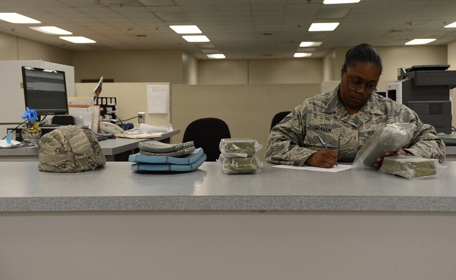 Staff Sgt. Toneichia Graham, 2nd Logistics Readiness Squadron mobility section, annotates equipment on a form for a customer on Barksdale Air Force Base, La., July 21, 2014. The mobility section is responsible for issuing and maintaining mission essential equipment to deploying Airmen, such as gas masks, weapons and body armor. (U.S. Air Force photo/Senior Airman Benjamin Gonsier)