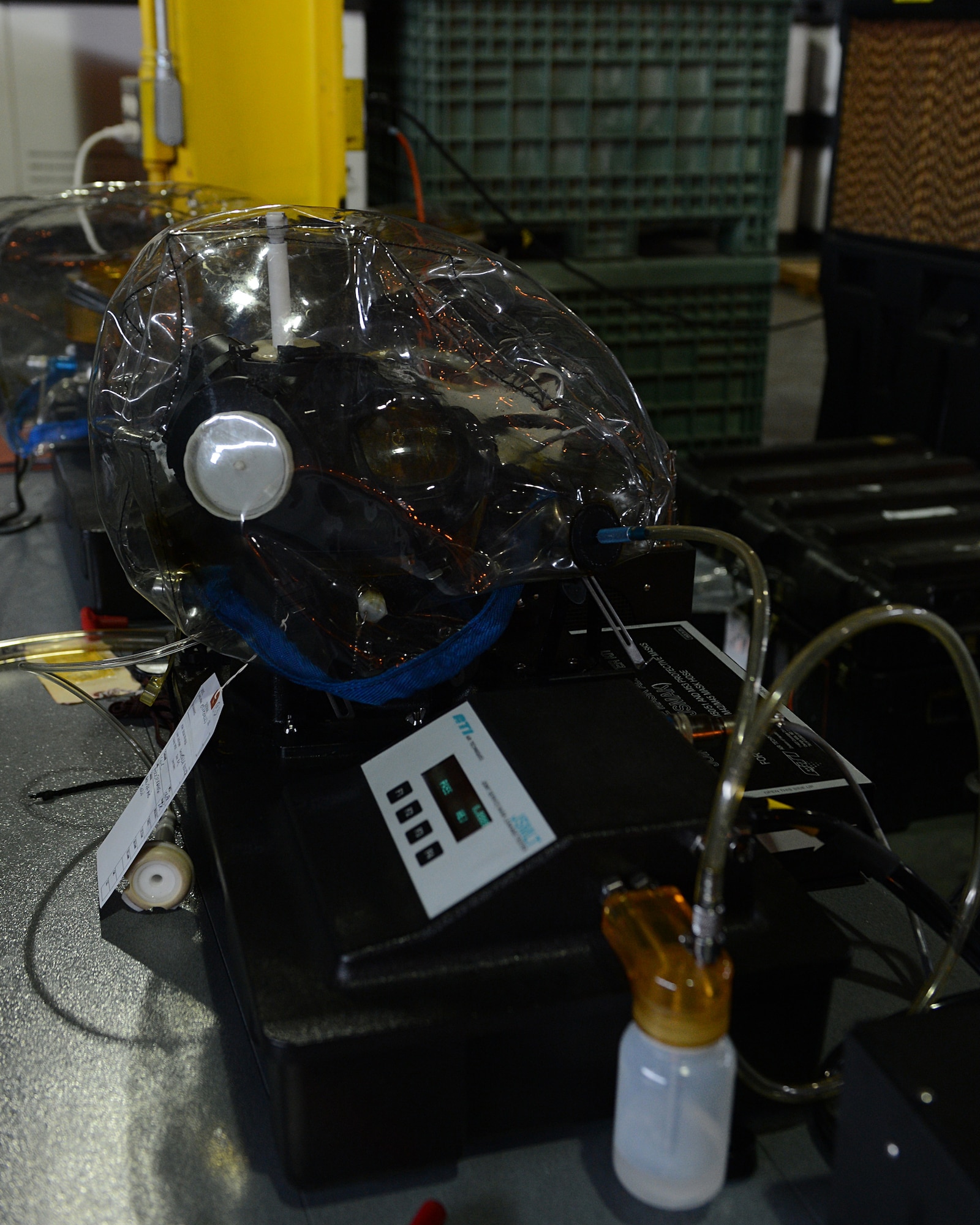 An M-50 Joint Service General Purpose Mask is tested for leakage on Barksdale Air Force Base, La., July 21, 2014. To test for leakage, a Joint Service Mask adapter kit is used, which allows the mask to be tested more accurately and does not require the operator to wear it. (U.S. Air Force photo/Senior Airman Benjamin Gonsier)
