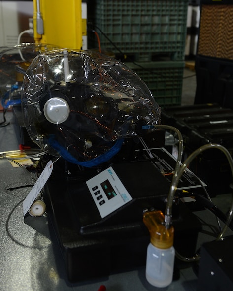 An M-50 Joint Service General Purpose Mask is tested for leakage on Barksdale Air Force Base, La., July 21, 2014. To test for leakage, a Joint Service Mask adapter kit is used, which allows the mask to be tested more accurately and does not require the operator to wear it. (U.S. Air Force photo/Senior Airman Benjamin Gonsier)