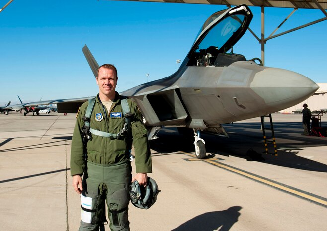 Maj. Matt Allen, a 706th Reserve Squadron full time air reserve technician, who is assigned to the 59th Test and Evaluation Squadron as an F-22 test director, stands by an F-22 Raptor before flight on July 21, 2014, at Nellis Air Force Base, Nev. On July 21, Allen officially became the seventh of all F-22 pilots, and the first one at Nellis AFB, to reach one thousand flying hours in the F-22. Allen reached this milestone during a test mission over the Utah Test and Training Range. One thousand flying hours is a significant moment for fighter pilots, it equates to roughly one thousand takeoffs and landings. Allen was quick to thank the maintainers and their efforts for maintaining and prepping the aircraft roughly one thousand times.  (U.S. Air Force photo by Airman 1st Class Rachel Loftis)