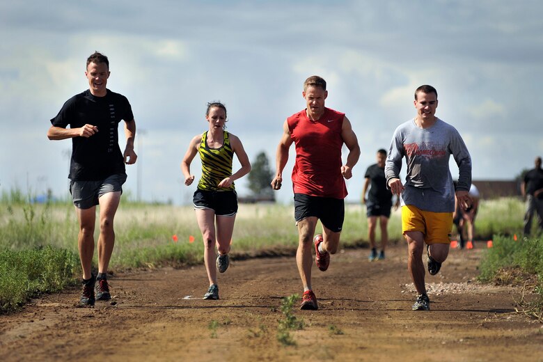 Monte Munoz and fellow teammates race through the Schriever Rough and Tough Scramble July 17, 2014, at Schriever Air Force Base, Colo. The mud race was one of the Schriever Week events July 14-18, 2014, which honored the installation’s history and recognized the people who support the daily mission. (U.S. Air Force photo/Dennis Rogers)