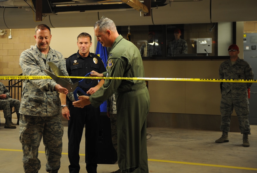 From left, U.S. Air Force Col. Brian Yates, Abilene Chief of Police Stan Standridge and U.S. Air Force Col. Steven Beasley, cut a ribbon at a dedication ceremony for the recently completed indoor firing range July 18, 2014, at Dyess Air Force Base, Texas. The new, state-of-the-art training range has 21 lanes and is rated to withstand up to a .50 caliber round. (U.S. Air Force photo by Airman 1st Class Alexander Guerrero/Released)