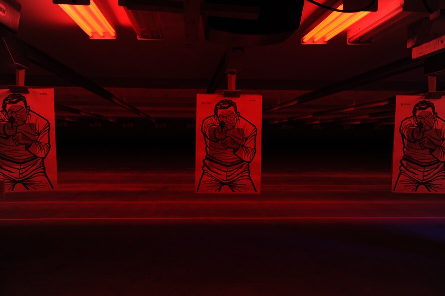 Several targets hang on the firing line in the newly-finished indoor firing range July 18, 2014, at Dyess Air Force Base, Texas. The $4.3 million facility allows training on multiple weapons platforms under day and simulated night-time conditions. (U.S. Air Force photo by Airman 1st Class Alexander Guerrero/Released)