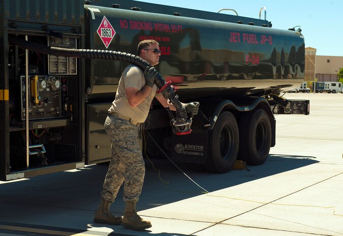 Senior Airman Daniel Millard, 419th Logistics Readiness Squadron fuels journeyman, prepares to fuel an aircraft participating in Red Flag 14-3, July 22, 2014, at Nellis Air Force Base, Nev. During Red Flag 14-3, Nellis is housing approximately 280 aircraft that are participating in the exercise, which depending on the aircraft, require anywhere between 800 to 1,500 gallons of fuel per aircraft for each flight, to be operational. (U.S. Air Force photo by Airman 1st Class Rachel Loftis) 