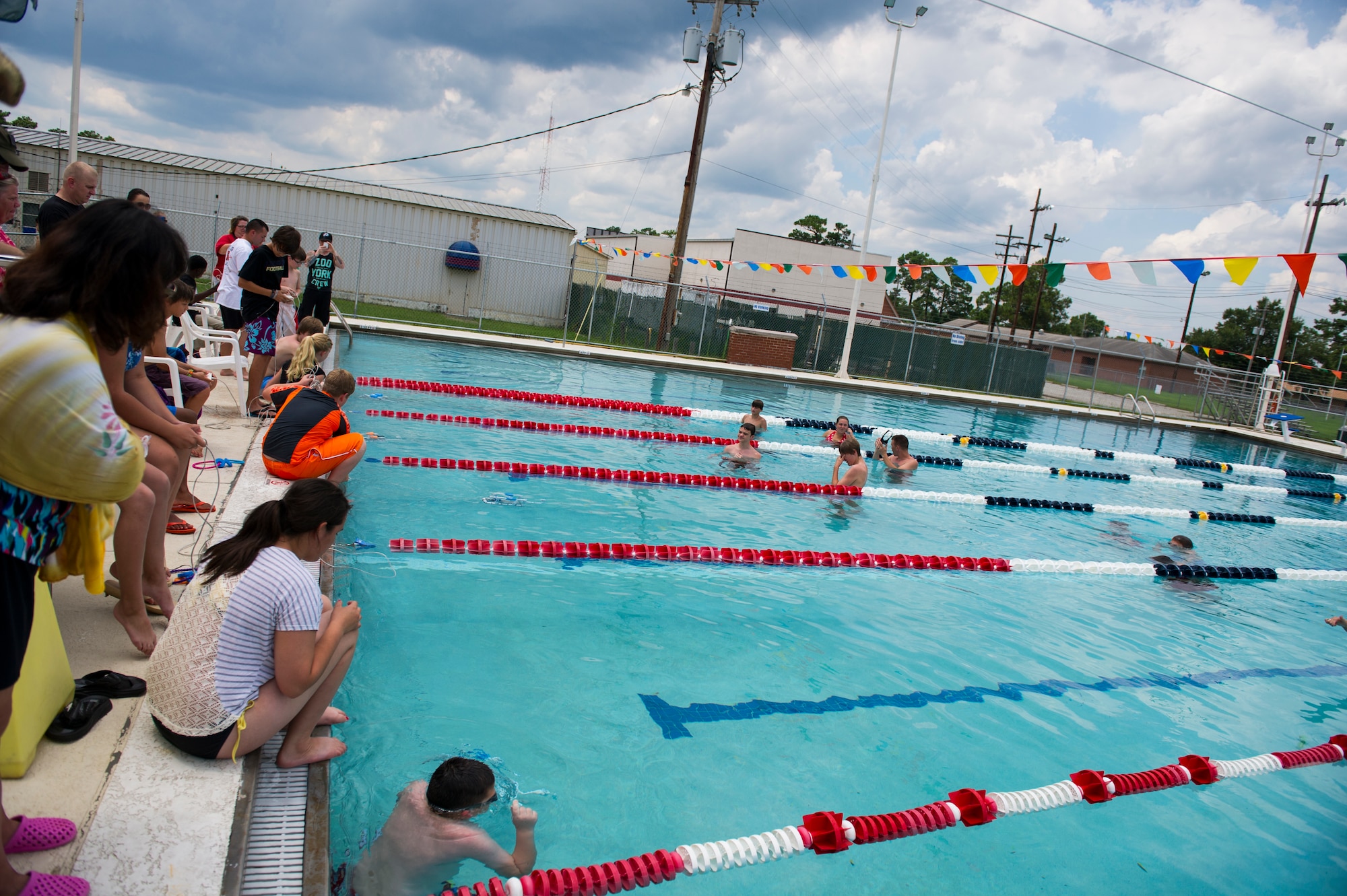 Dependent children immerse their SeaPerch submarines into a pool for a team based competition, July 18, 2014, at Joint Base Charleston, S.C. Soldiers from Ft. Jackson, S.C., volunteered to help military children with the SeaPerch program, which provides students with the opportunity to learn about robotics, engineering, science, and mathematics (STEM) while building an underwater remotely operated vehicle. (U.S. Air Force photo/Senior Airman George Goslin)