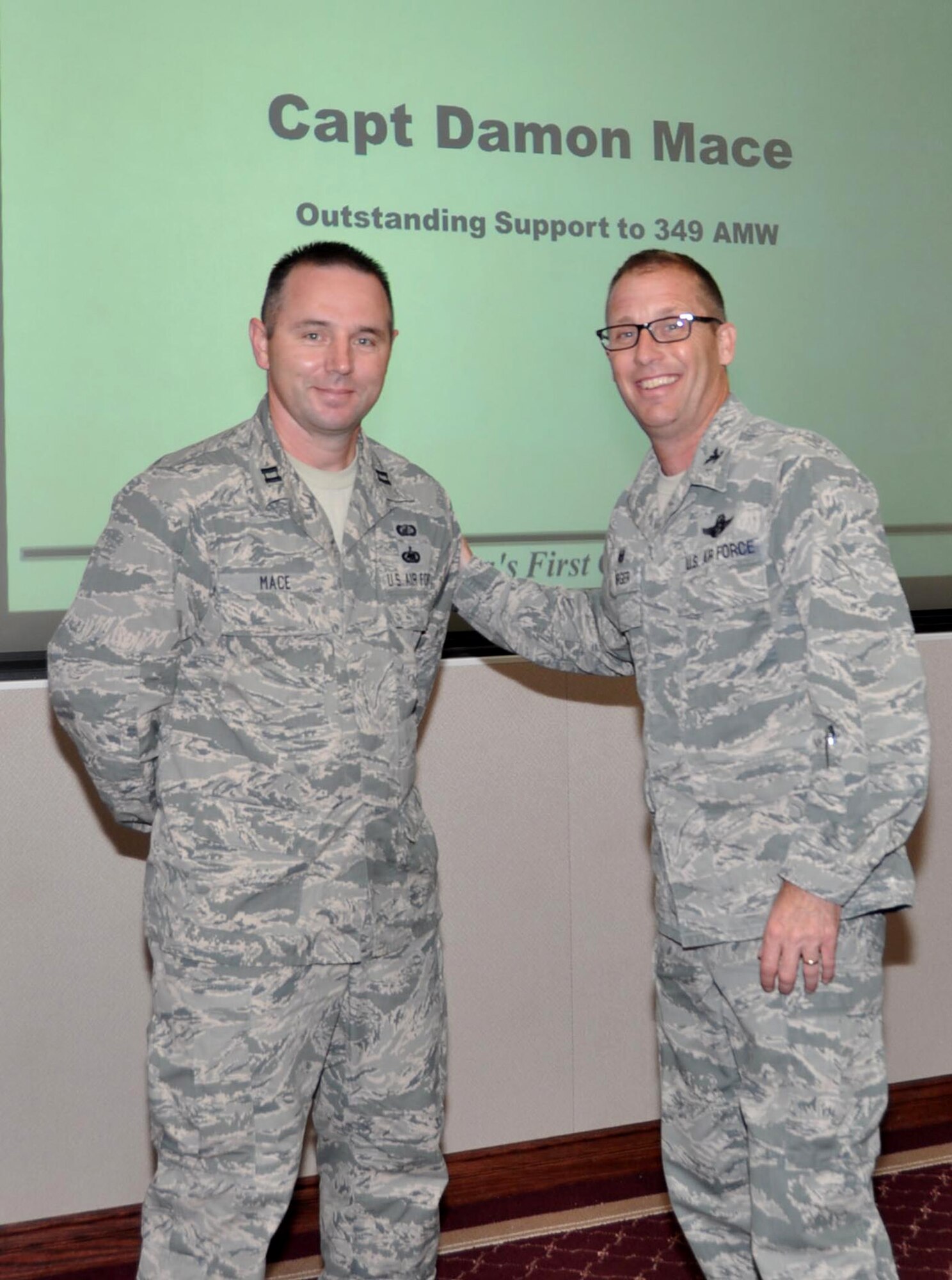 TRAVIS AIR FORCE BASE, Calif. At the 60th Air Mobility Wing July 9, 2014 Standup, Capt. Damon Mace was recognized by Col. Matt Burger, 349th AMW commander. The captain and his team went above and beyond to help the reservists complete travel pay and voucher requests successfully. (U.S. Air Force photo/A1C Amber L. Carter)