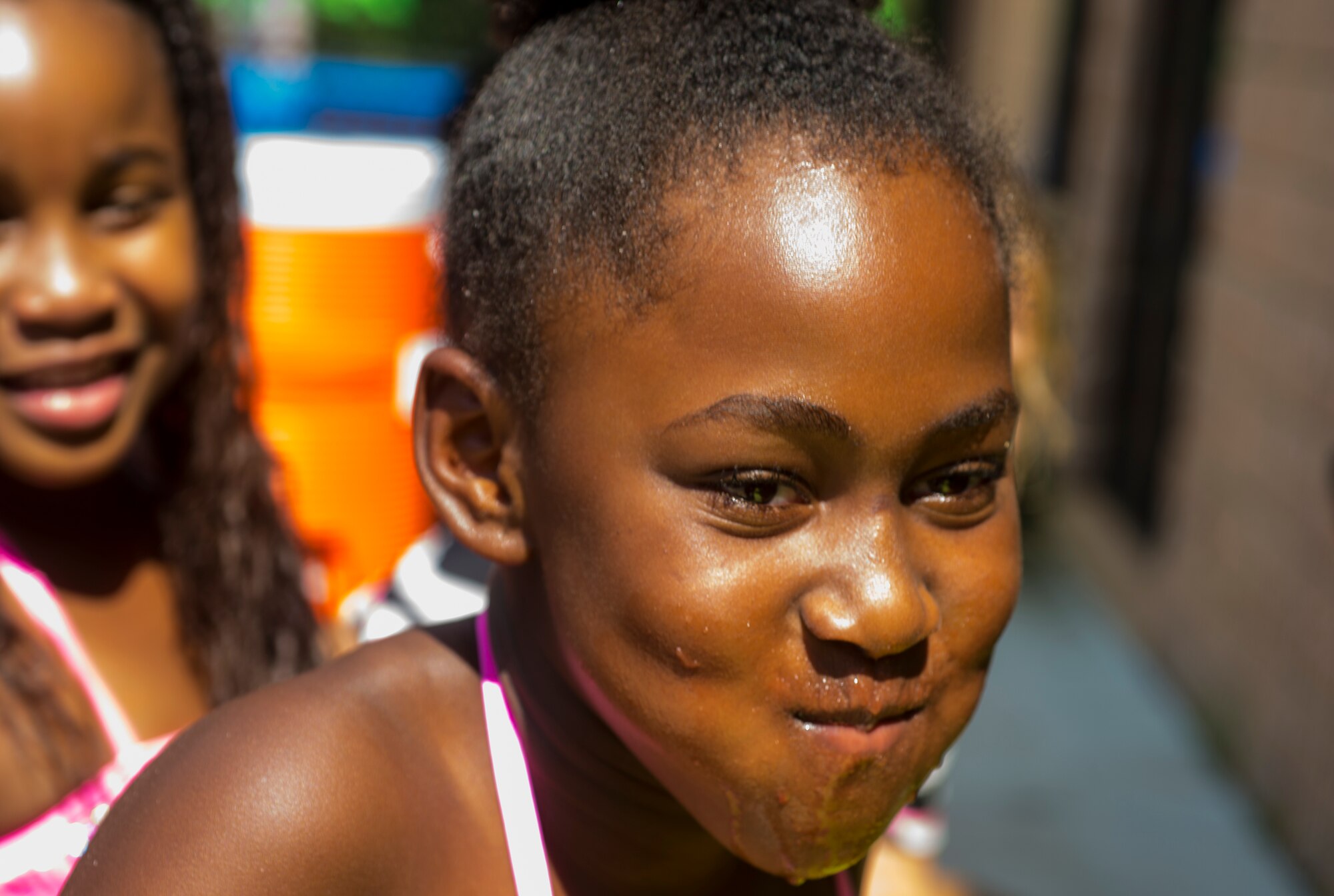 Janay Hill, daughter of U.S. Air Force Maj. Darren Hill, 23d Force Support Squadron, shows her victory face during the July Jamboree at Moody Air Force Base, Ga., July 22, 2014. Janay won the watermelon eating contest where youth competed to eat the fastest without using their hands. (U.S. Air Force photo by Airman 1st Ceaira Tinsley/
Released)
