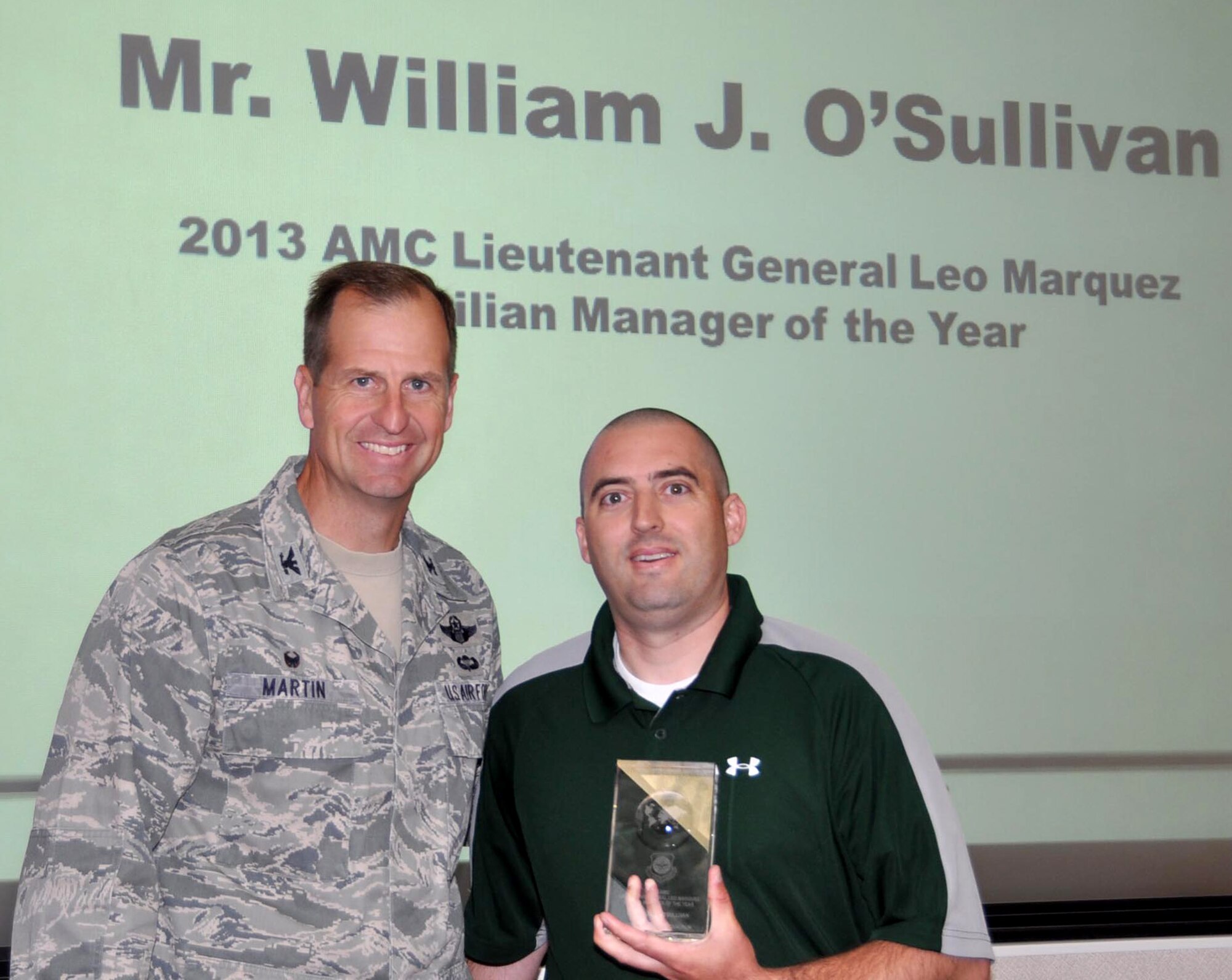 TRAVIS AIR FORCE BASE, Calif. -- 349th Air Mobility Wing reservist, Master Sgt. William J. O’Sullivan, was recognized at the July 9, 2014 60th AMW Standup. He is pictured here with Col. Corey Martin, 60th AMW commander, who presented the award. (U.S. Air Force photo/A1C Amber L. Carter)