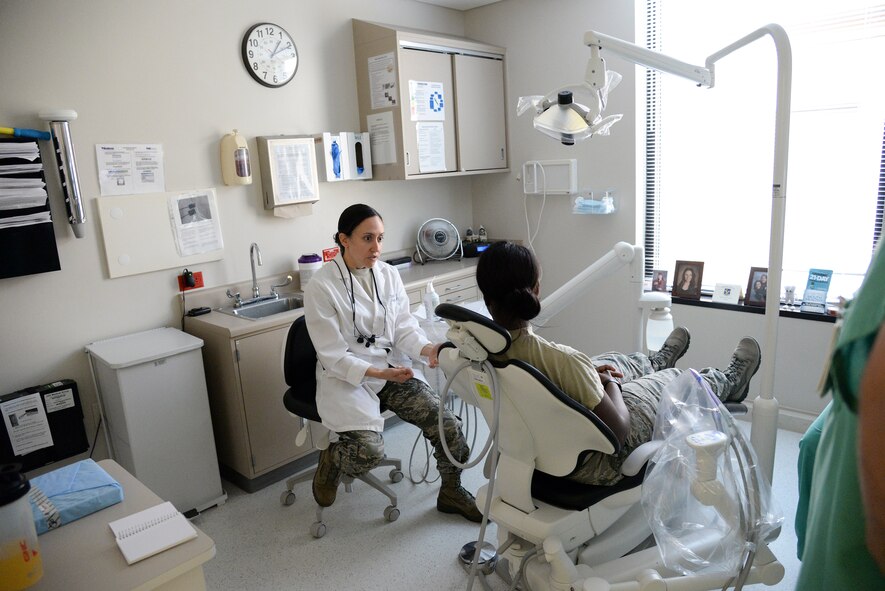U.S. Air Force Capt. (Dr.) Jamie Smith, 23d Aeromedical Dental Squadron dentist, concludes a dental appointment with Airman 1st Class Ceaira Tinsley, 23d Wing Public Affairs photojournalist at Moody Air Force Base, Ga., July 22, 2014. Smith gave Tinsley treatment options and suggestions to mitigate pain. (U.S. Air Force photo by Airman 1st Class Sandra Marrero/Released)
