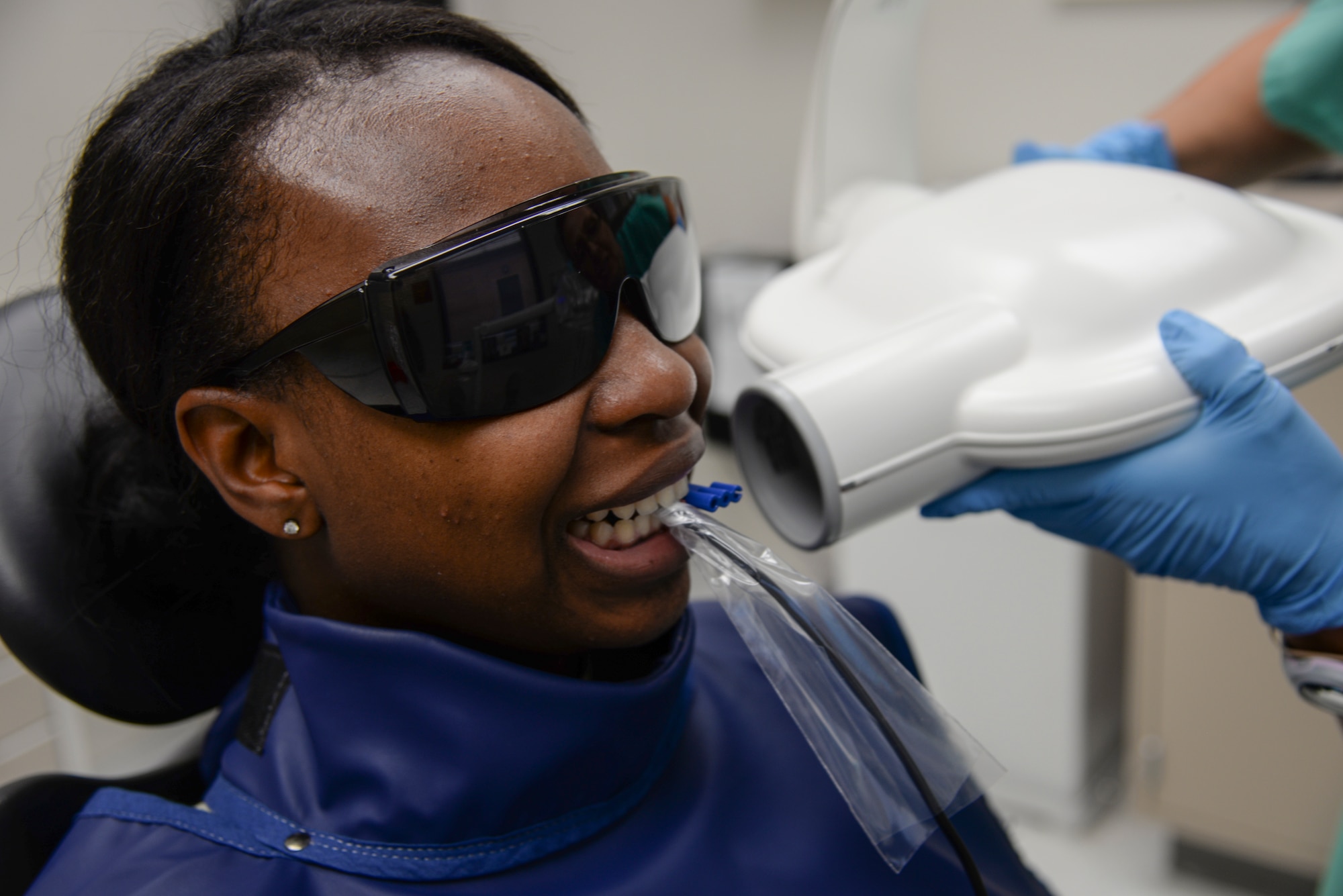 U.S. Air Force Airman 1st Class Ceaira Tinsely, 23d Wing public affairs photojournalist, receives an x-ray at the 23d Medical Group dental clinic at Moody Air Force Base, Ga. July 22, 2014. The x-ray was used to check for any damage to Tinsely’s tooth or filling. (U.S. Air Force photo by Airman 1st Class Sandra Marrero/Released)
