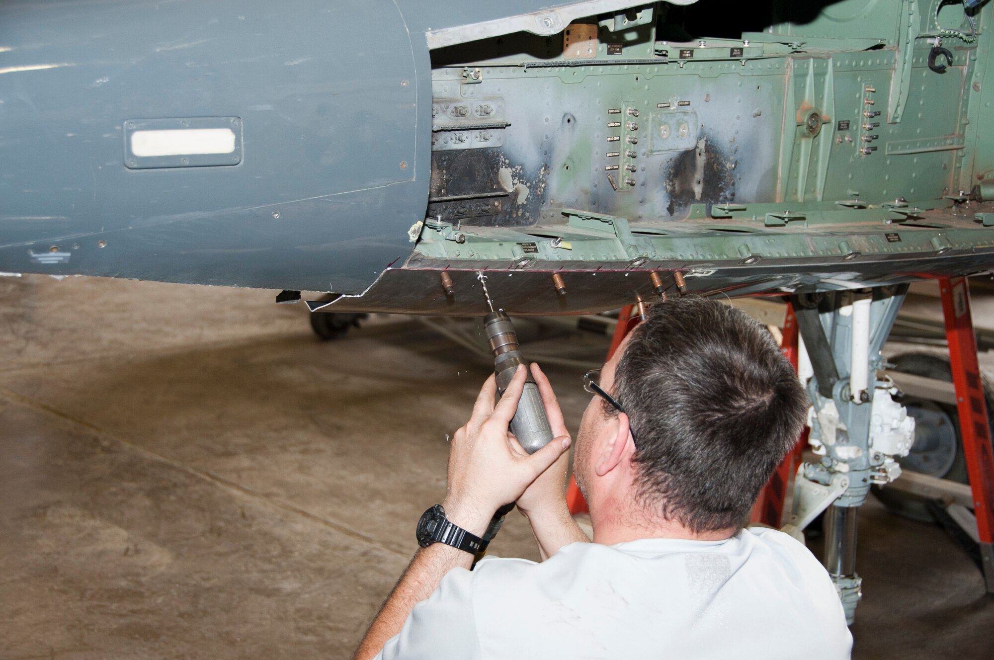 Volunteers work diligently to restore a T-38 Talon at Sheppard Air Force Base, Texas, July 19, 2014. Once completed, the T-38 will be on display next to a 98-year-old Jenny biplane inside the newly renovated Wichita Falls Municipal Airport, embodying the partnership shared by Sheppard and the local community. (U.S. Air Force photo/Airman 1st Class Robert L. McIlrath)