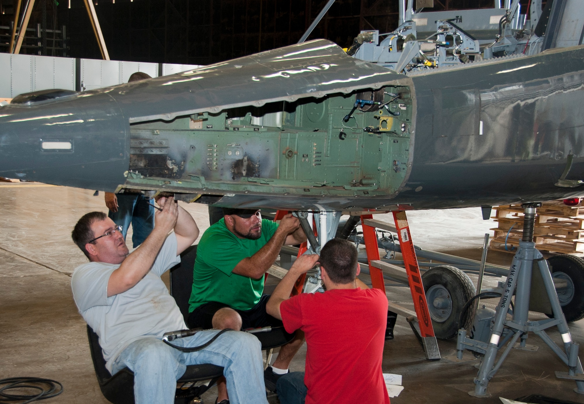 Volunteers work diligently to restore a T-38 Talon at Sheppard Air Force Base, Texas, July 19, 2014. Once completed, the T-38 will be on display next to a 98-year-old Jenny biplane inside the newly renovated Wichita Falls Municipal Airport, embodying the partnership shared by Sheppard and the local community. (U.S. Air Force photo/Airman 1st Class Robert L. McIlrath)