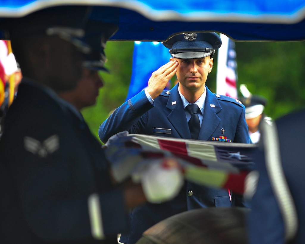 Chaplain Capt. Matthew Dussia, a chaplain with the 325th Fighter Wing, salutes the remains of Capt. Robert Turnbull Sr., July 19. Turnbull was laid to rest in Barnetts Creek Baptist Church Cemetery, Thomas County, Ga. (U.S. Air Force photo by Airman 1st Class Dustin Mullen)