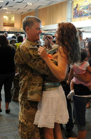 Staff Sgt. Alexander Bustard, a member of the 341st Civil Engineer Squadron deployed to Southwest Asia, was welcomed home by his wife, Kari, July 22 at the Great Falls International Airport, Great Falls, Mont. Families and friends waited six months for their loved ones to return home from deployment. (U.S. Air Force photo/Airman 1st Class Joshua Smoot)