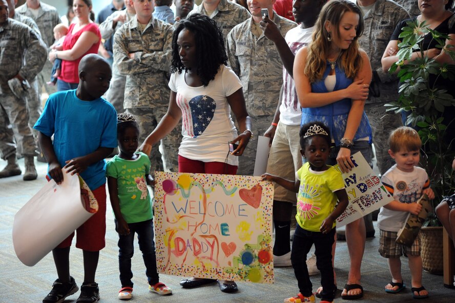 Families and friends anxiously wait at Great Falls International Airport, Great Falls, Mont., for the arrival of 15 Airmen who were deployed for six months to Southwest Asia, July 22. Dozens of people, including spouses and members of 341st CES joined together to greet the Airmen. (U.S. Air Force photo/Airman 1st Class Joshua Smoot)