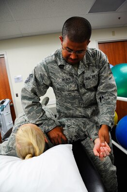 Tech. Sgt Hugo Reinor, 341st Medical Group physical therapy technician, demonstrates range of motion techniques, which are used to help rehabilitate injured patients with shoulder issues. The physical therapy technician or physical therapist will gently assist the patient, working the joint through a natural level of resistance. The motion demonstrated helps stretch external rotation of the shoulder, which increases range of motion. (U.S. Air Force photo/Airman 1st Class Collin Schmidt)