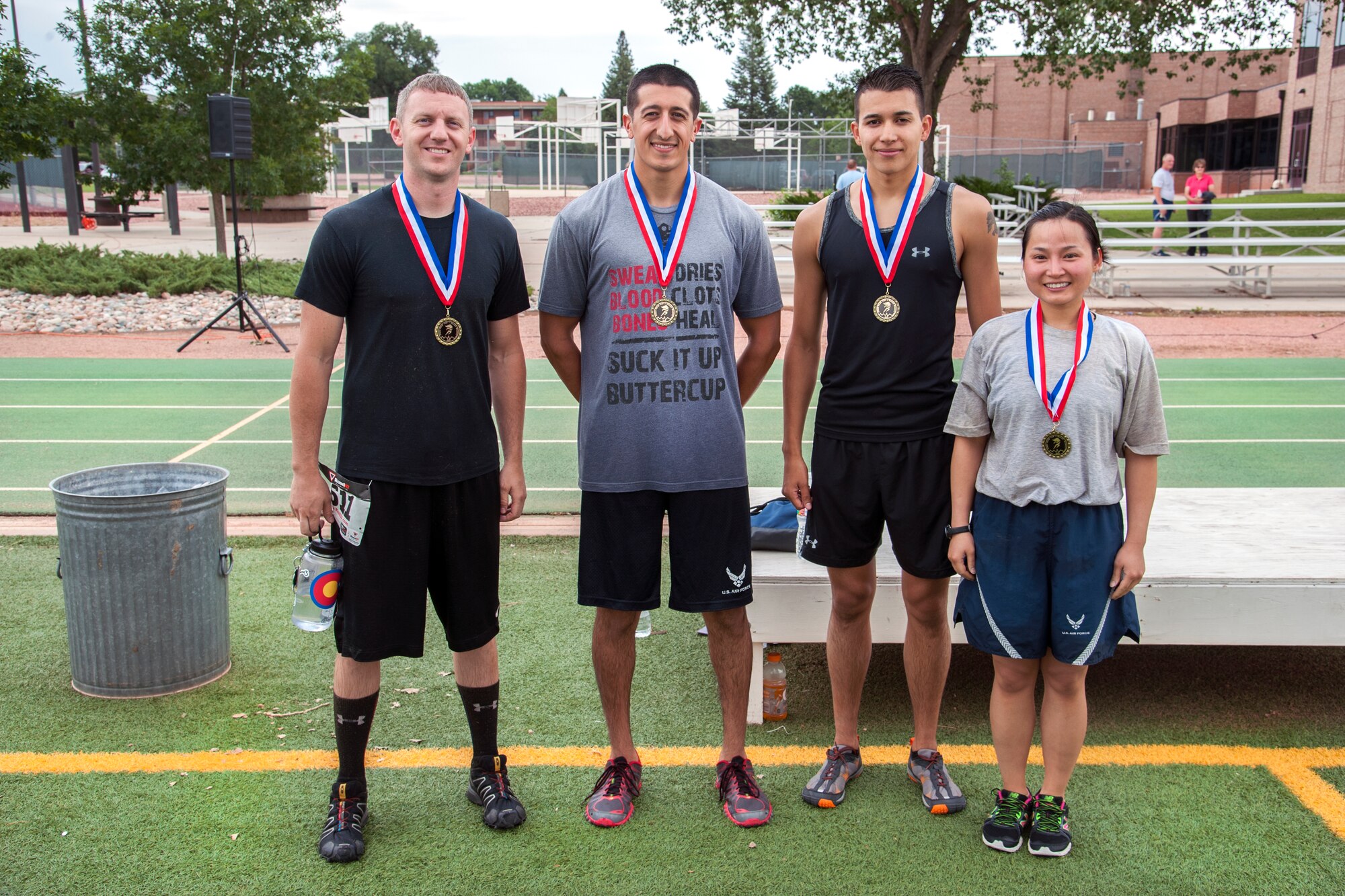 PETERSON AIR FORCE BASE, Colo. – The Honey Badgers, from left to right, Staff Sgt. Thomas Rentschler, Senior Airman Derrek Deherrera, Airman 1st Class Javier Ruiz and Staff Sgt. Tran Le, all from the 21st Communications Squadron won “Wacky Warfit” with a time of 30 minutes, 22 seconds. Warfit is monthly and is normally a 5K run. This month the event was held July 26 and was “Wacky,” so the length was increased to 3.25 miles and comprised of nine obstacles, including mud pits, water hazards and barriers. (U.S. Air Force photo/ Craig Denton)