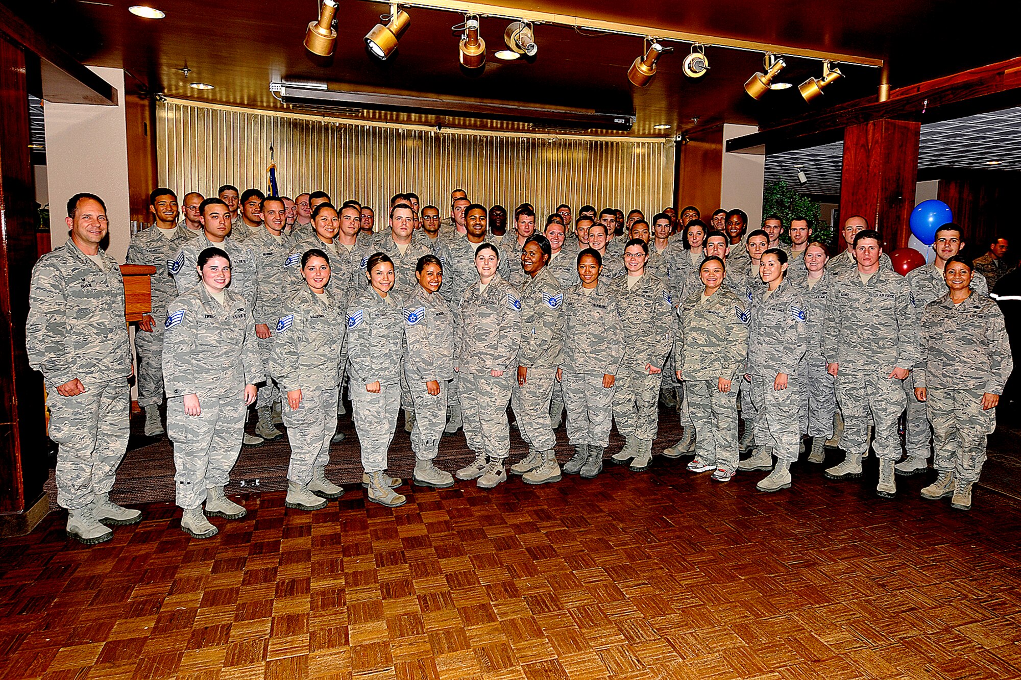 PETERSON AIR FORCE BASE, Colo. — Col. John Shaw, 21st Space Wing commander, and Chief Master Sergeant Idalia Peele, 21st Space Wing command chief, attend a celebration for the 59 Team Pete Airmen chosen for staff sergeant. The staff sergeant promotion release party took place at the Peterson Club July 15. (U.S. Air Force photo/Dennis Howk)