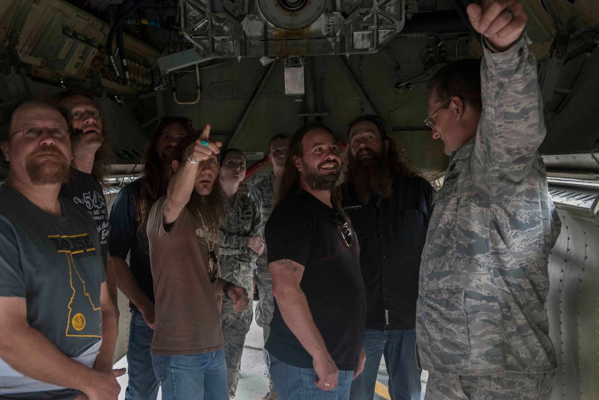 Blackberry Smoke band members tour the underside of a B-52H Stratofortress static display at Minot Air Force Base, N.D., July 21, 2014. During their USO tour of the base, the band members also saw the Uniform-1 training site and dining facility. (U.S. Air Force photos/Airman 1st Class Lauren Pitts)  