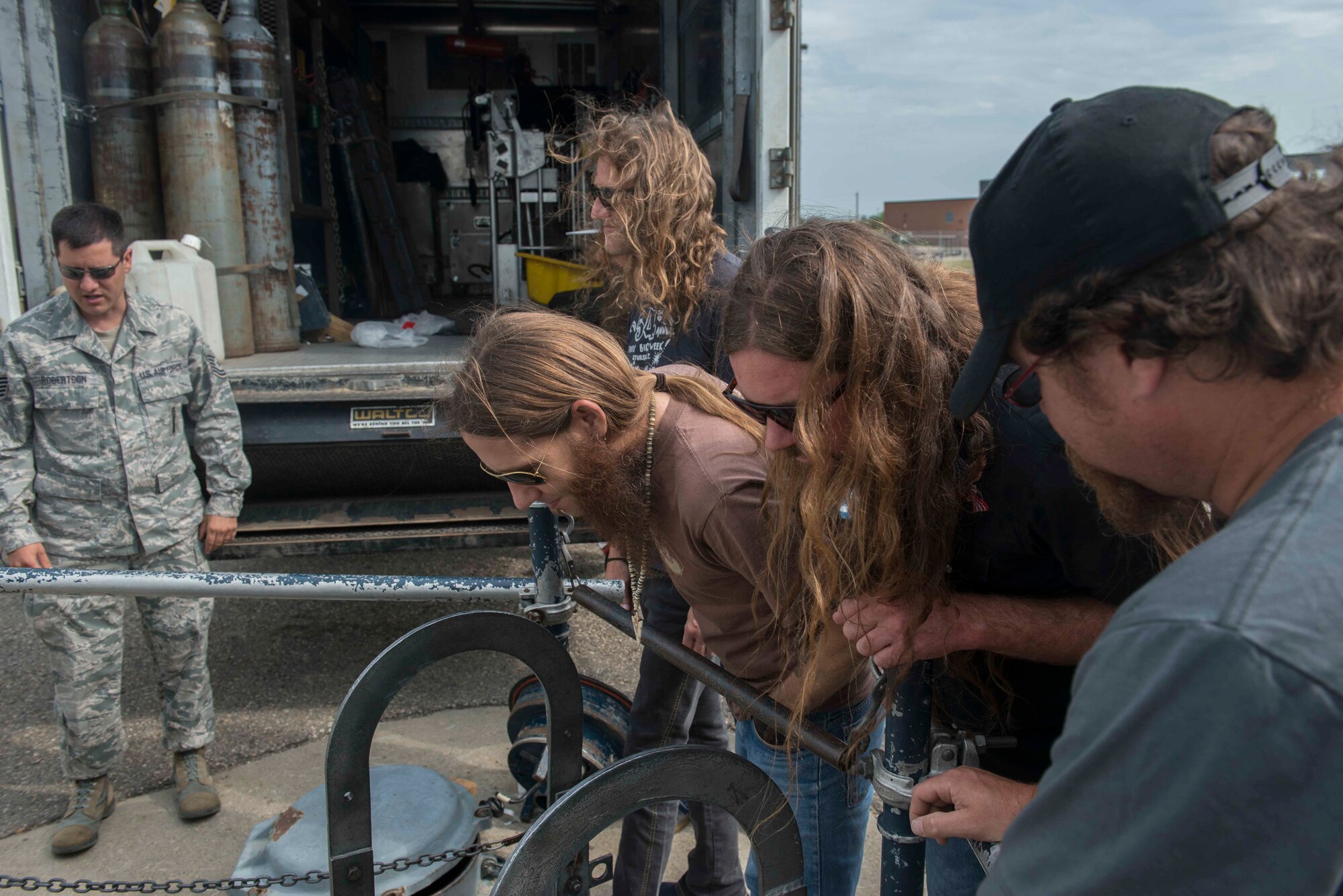 Members of Blackberry Smoke look down into a missile silo at Minot Air Force Base N.D., at the Uniform-1 training site July 21, 2014. Minot AFB was the first stop on the band’s USO tour. (U.S. Air Force photos/Airman 1st Class Lauren Pitts)  