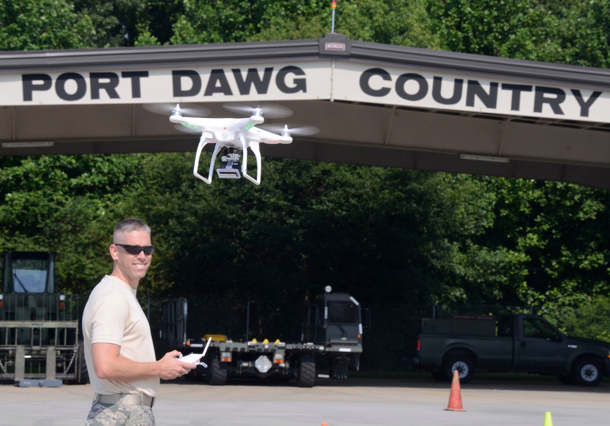 Staff Sgt. Gary Martin, from the 80th Aerial Port Squadron, Dobbins Air Reserve Base, Ga., demonstrates the operation of the Phantom 2 quad copter with an attached Go Pro Hero 3 video camera used for capturing video and still photo imagery supporting the mission of the Air Force Reserve Command Transportation Proficiency Center on Dobbins July 8, 2014. (U.S. Air Force photo/Don Peek)

