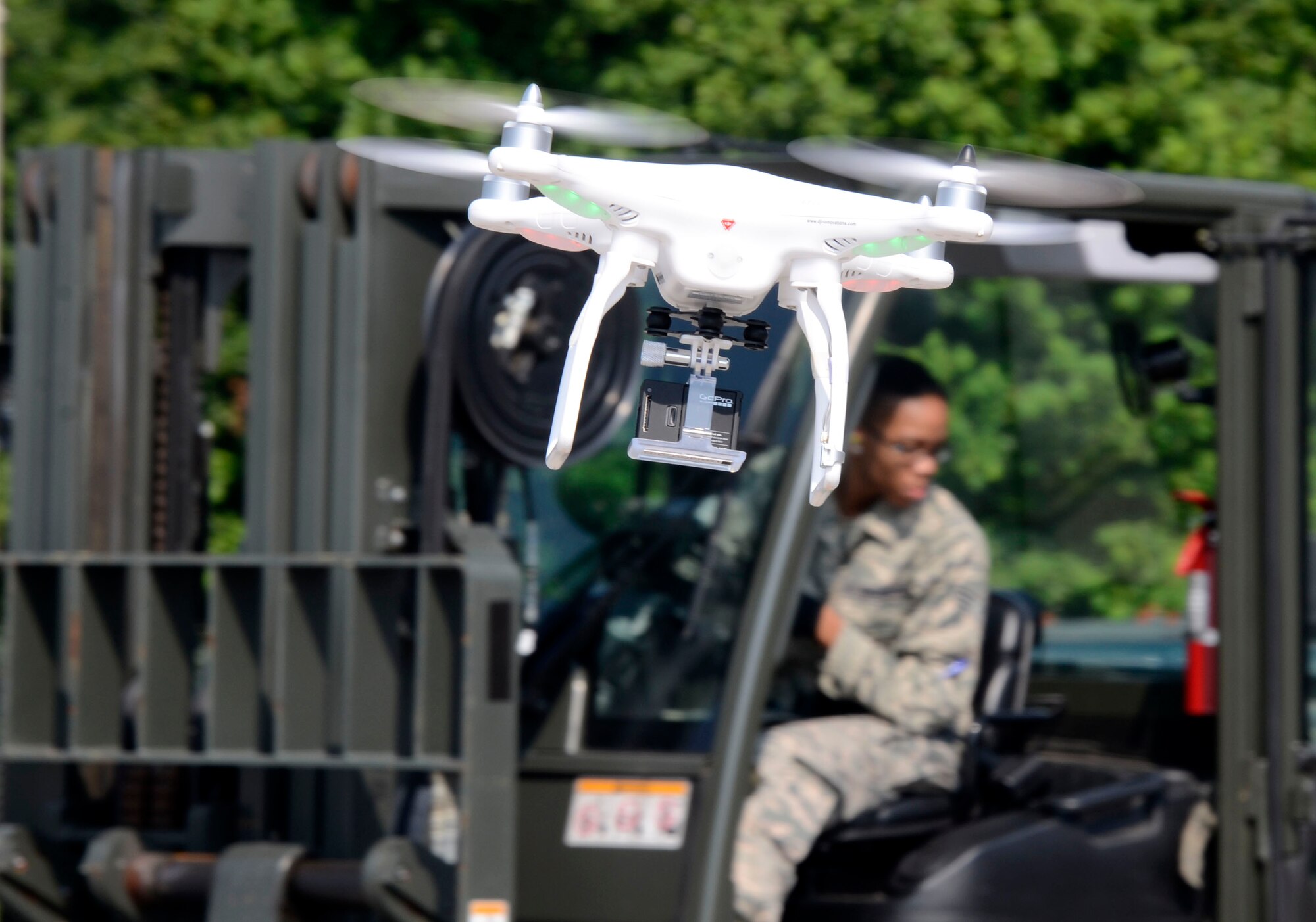 The Phantom 2 quad copter with an attached Go Pro Hero 3 video camera captures video and still photo imagery in a demonstration at the Air Force Reserve Command Transportation Proficiency Center, Dobbins Air Reserve Base, Ga., July 8, 2014. (U.S. Air Force photo/Don Peek)