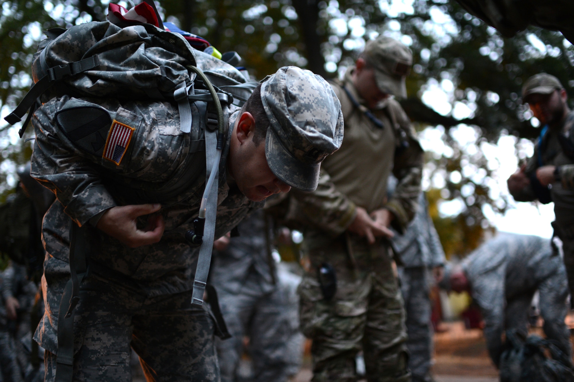 U.S. Army Capt. Patrick Muldoon, 52nd Fighter Wing ground liaison officer dons his ruck during the International Four Days Marches Nijmegen in Nijmegen, Netherlands, July 16, 2014. Military participants in the event had to march with a ruck that weighed a minimum of ten kilograms at all times, or face disqualification of the final award. (U.S. Air Force photo by Senior Airman Gustavo Castillo/Released)