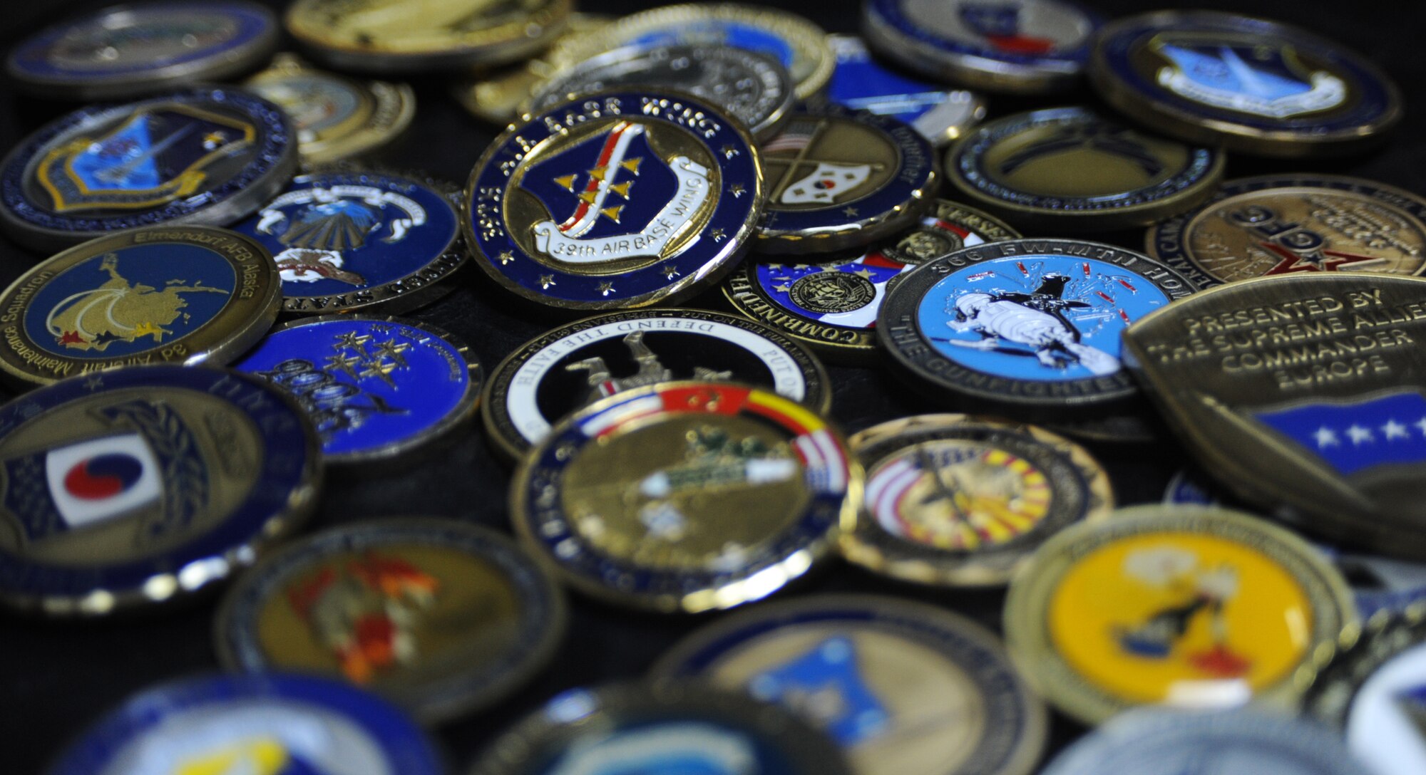 The 39th Air Base Wing is conducting a contest open to all personnel currently assigned to the wing that will allow military members and civilians alike to vie for the title of "best story" behind their favorite coin. The contest will run throughout the month of August and the winner will be determined by which story and accompanying photo receive the most "likes" on the wing's official Facebook page. (U.S. Air Force photo illustration by Capt. David Liapis/Released)