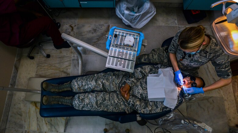 Capt. Leslie Jones, 39th Medical Group dentist, examines the teeth of Master Sgt. Francesca Seehausen, 39th MDG dental flight chief July 22, 2014, Incirlik Air Base, Turkey.  The 39th MDG dental clinic provides care to the base populace to keeps service members mission-ready and worldwide deployable. (U.S. Air Force photo by Senior Airman Nicole Sikorski/Released)

