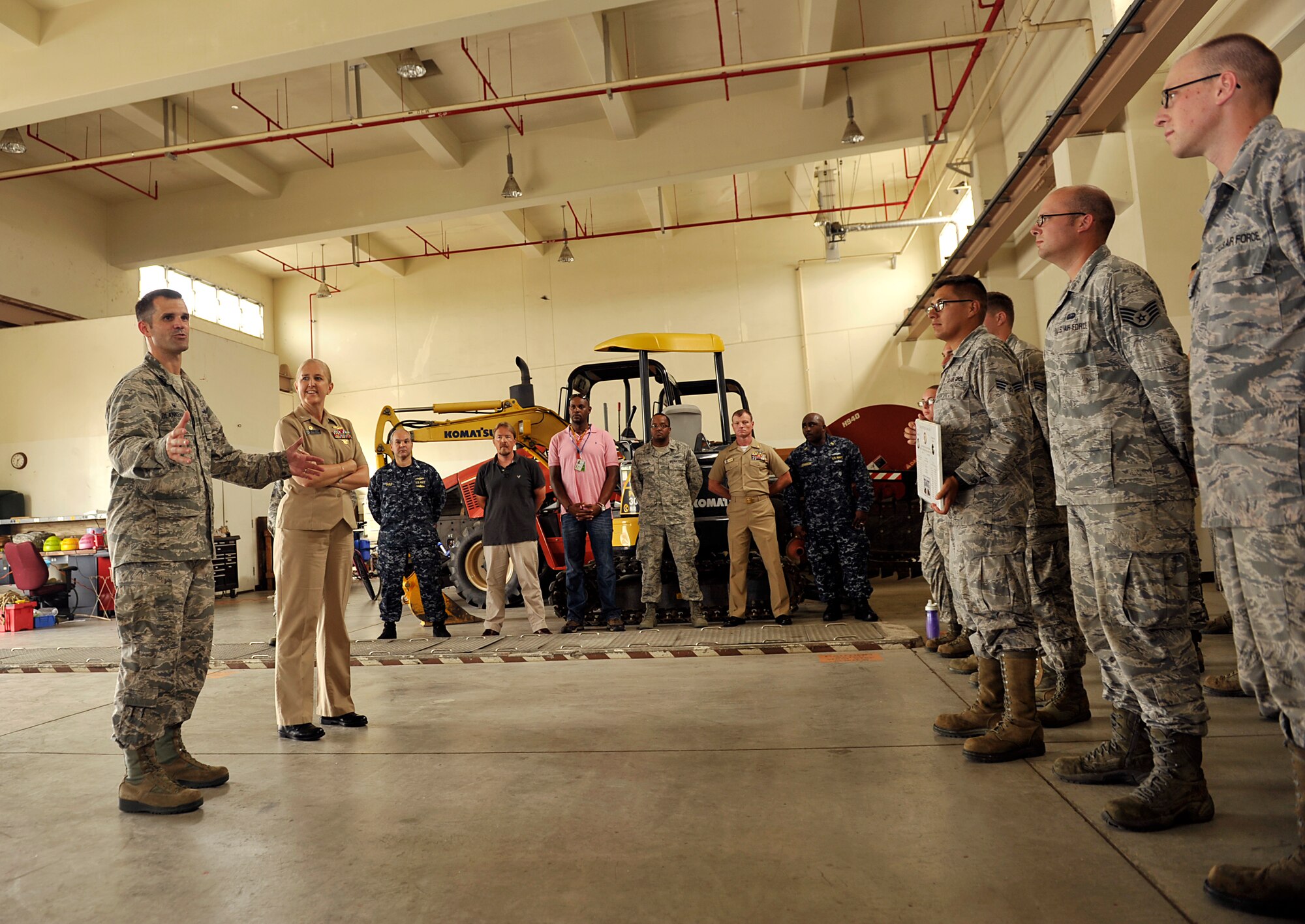U.S. Air Force Lt. Col. Jeffrey Blankenship, 18th Communications Squadron commander, thanks members of the 18th CS cable and antenna shop after a plaque presentation on Kadena Air Base, Japan, July 22, 2014. Thirty-two military members and 27 master labor contractors were involved in the first-ever ribbon fiber placement in Okinawa. The Navy 864 circuit ribbon fiber optic cable, approximately 26,000 feet long, was placed between Kadena Air Base and Camp Shields. The fiber optic cable significantly expands the IT backbone infrastructure between the two installations, and will increase the rate of communication. (U.S. Air Force photo by Naoto Anazawa/Released)