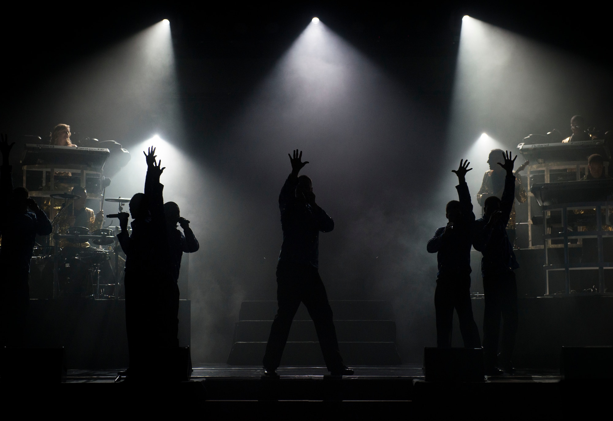 Members from Tops in Blue finish a performance at the Taiyo Community Center at Yokota Air Base, Japan, July 22, 2014. Lighting play a key role in performances to help complete the show. (U.S. Air Force photo by Airman 1st Class Meagan Schutter/Released)