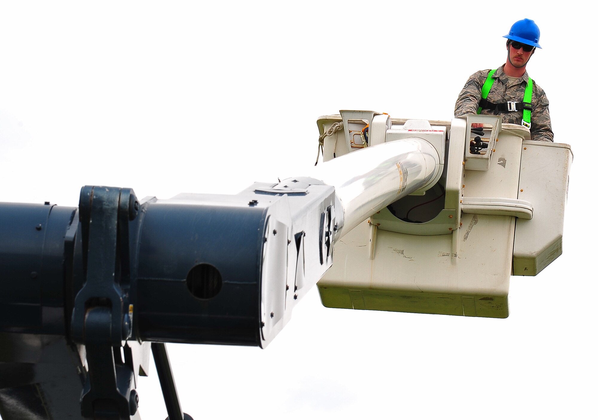 U.S. Air Force Senior Airman Jonathan Bagby, 373rd Support Squadron Mission Installation and Antenna Team technician, ascends on a vehicle mounted aerial device at Misawa Air Base, Japan, July 9, 2014. As part of his duties, he executes unscheduled and preventive maintenance on more than 30 site antennas and communications systems, as well as provide host base antenna maintenance support. (U.S. Air Force photo/Senior Airman Jose L. Hernandez-Domitilo)