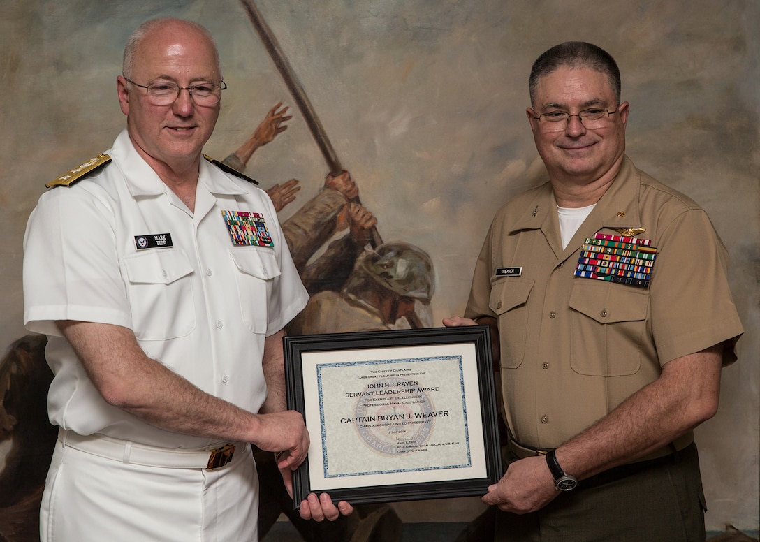 Rear Adm. Mark Tidd,left, head of the Chaplain Corps, stands with Navy Capt. Bryan Weaver, year’s John H. Craven Servant Leadership Award on July 18, 2014, on Parris Island, S.C. The annual award is peer nominated and named after Chaplain John H. Craven for his selfless dedication to providing support for Marines and sailors through some of the worst battles of World War II and Korea. Weaver is from Roaring Spring, Pa.  (Photo by Cpl. David Bessey)
