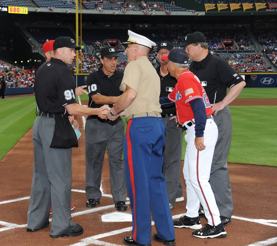 Col. Don Davis, commanding officer, Marine Corps Logistics Base Albany, shakes hands with Atlanta Braves coaches and game officials during the pre-game ceremony, Saturday.  Davis served as the Atlanta Braves honorary team captain during the Marine Corps Appreciation Day, July 19, at Turner Field in Atlanta, Georgia.