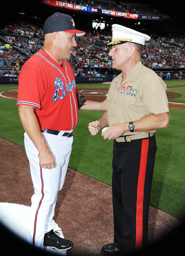 Maj. Gen. John J. Broadmeadow, commanding general, Marine Corps Logistics Command, receives an autographed baseball from Atlanta Braves manager Fredi Gonzalez during the pre-game tribute, July 19.  Broadmeadow threw out the celebratory first pitch as part of the Marine Corps Appreciation Day at Turner Field in Atlanta, Georgia.