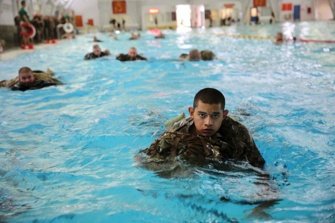 Recruits of Kilo Company, 3rd Recruit Training Battalion, conduct a 25-meter swim utilizing a back pack as a floatation device at Marine Corps Recruit Depot San Diego, July 21. The exercise was part of a swim qualification all recruits must pass in order to become Marines.