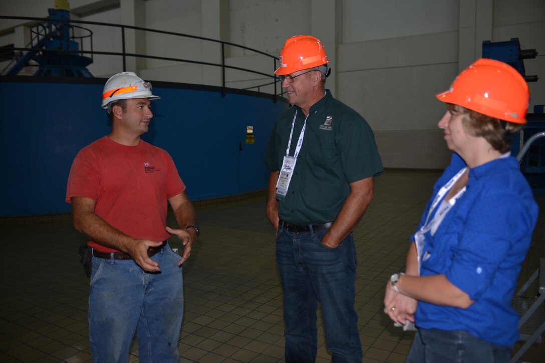 Brian Jones, (Left) Lake Barkley Power Plant Mechanic answers questions from Dave and Judy Kamper from Ripon, CA.  The two are a part of a tour group attending the HydroVision conference in Nashville, Tenn., at the Music City Center. 