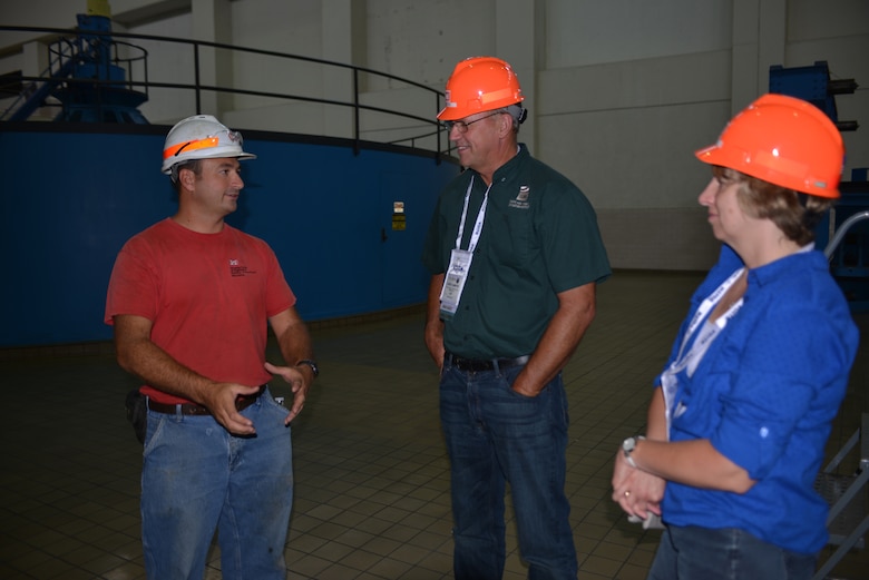Brian Jones, (Left) Lake Barkley Power Plant Mechanic answers questions from Dave and Judy Kamper from Ripon, CA.  The two are a part of a tour group attending the HydroVision conference in Nashville, Tenn., at the Music City Center. 