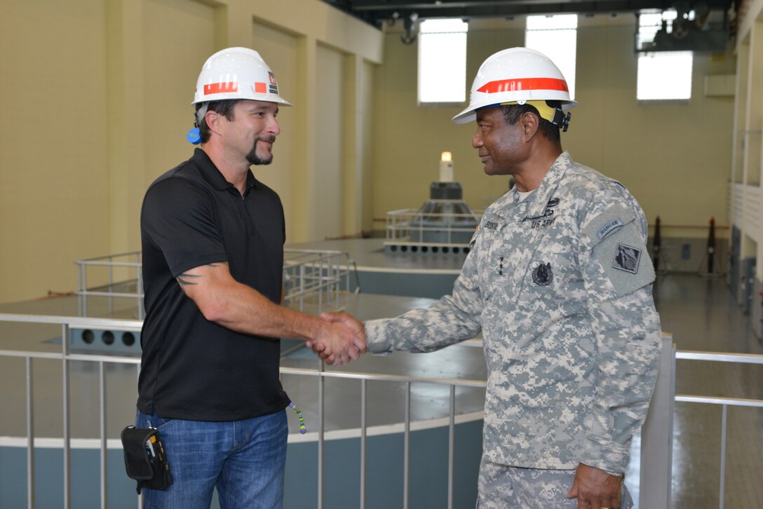 Lt. Gen. Thomas P. Bostick, the Army's chief of engineers and USACE commanding general presents Ron Gatlin, Center Hill Dam Hydro power electrician with a general’s command coin during a tour at the Center Hill Dam July 22, 2014.