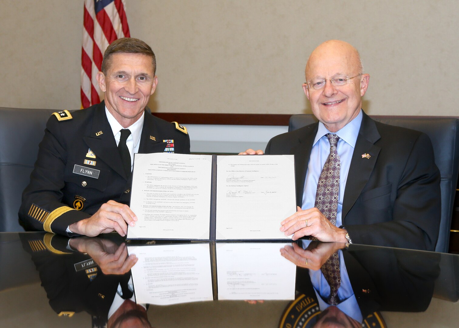 DIA Director Lt. Gen. Michael Flynn and Director of National Intelligence James Clapper acknowledge the official transfer of responsibility for the IC Wounded Warrior Program with a memorandum of understanding at ODNI Headquarters June 24. The MOU reflects the DNI’s continuing responsibilities for strategic oversight of the program and DIA’s day-to-day, IC-wide program management responsibilities. 