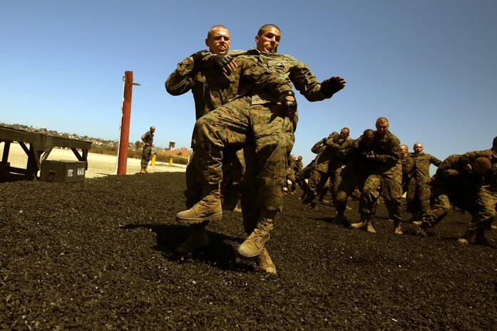 Recruits Garrett Stevens and Bryce P. Schmidt, Platoon 3223, Kilo Company, 3rd Recruit Training Battalion, practice the counter to the rear headlock during a Marine Corps Martial Arts Program session at Marine Corps Recruit Depot San Diego, July 21. The primary objective of MCMAP is to teach recruits how to fight and defend themselves, however an equally important second objective is for them to learn discipline and warrior ethos. Stevens is a native of Germantown, Wis. Schmidt is a native of West Bend, Wis. They were both recruited out of Recruiting Substation West Bend, Wis.
