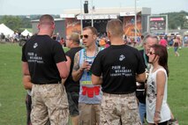 Marines with Marine Corps Recruiting Station Twin Cities speak to concert-goers at RockFest 2014 in Cadott, Wisconsin. During the music festival, fans of Aerosmith and Rob Zombie conducted pull ups with the RS Twin Cities Marines.