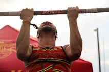 A concert-goer conducts pull ups at RockFest 2014 in Cadott, Wisconsin. During the music festival, fans of Aerosmith and Rob Zombie conducted pull ups with the RS Twin Cities Marines.
